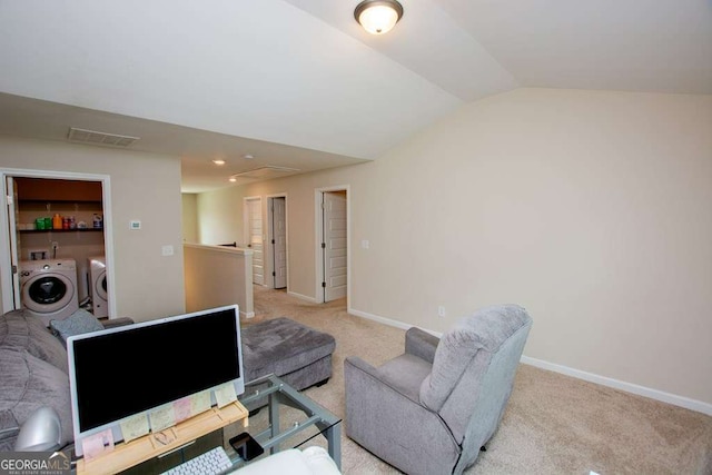 carpeted home office featuring washing machine and clothes dryer and vaulted ceiling