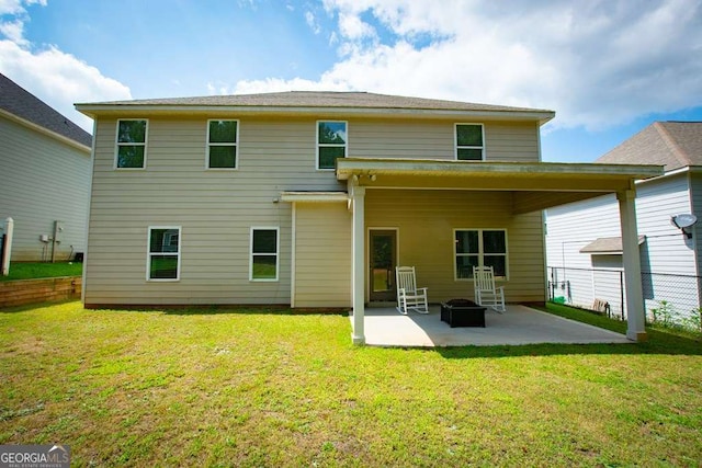 rear view of house featuring a yard and a patio