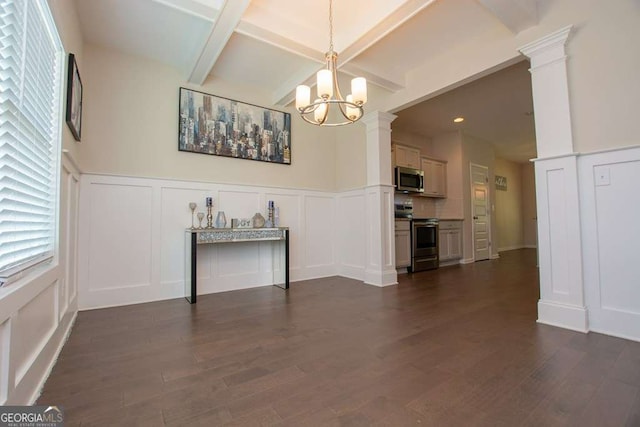 unfurnished dining area featuring a chandelier, dark hardwood / wood-style floors, and ornate columns