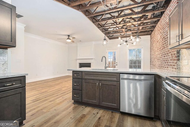 kitchen with dark brown cabinetry, decorative backsplash, sink, and stainless steel appliances