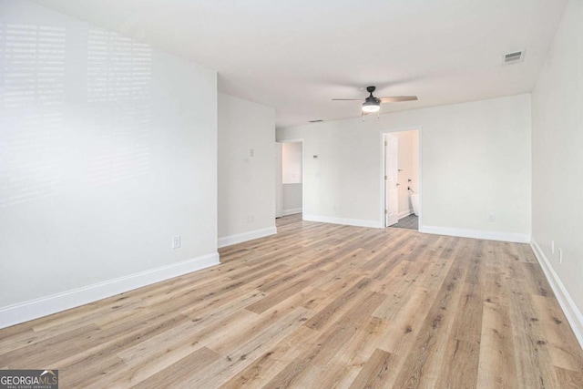 empty room with light wood-type flooring and ceiling fan