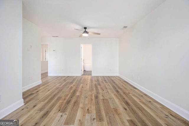 empty room with ceiling fan and light wood-type flooring