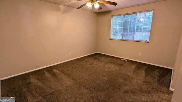 spare room featuring ceiling fan, carpet floors, and a textured ceiling