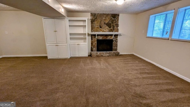 unfurnished living room with a fireplace, a textured ceiling, and carpet flooring