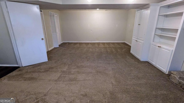 spare room featuring dark carpet