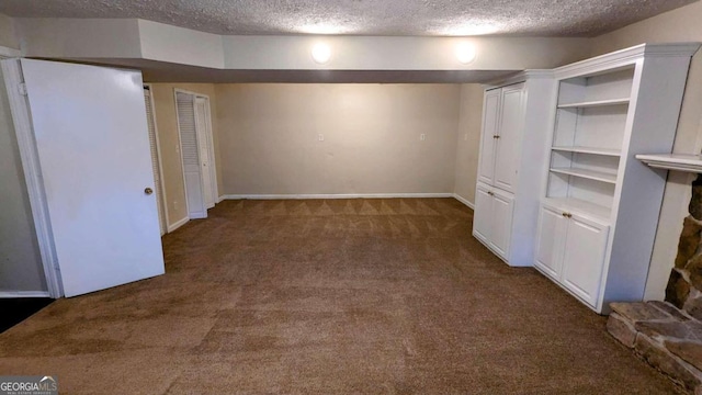 unfurnished bedroom featuring dark carpet and a textured ceiling