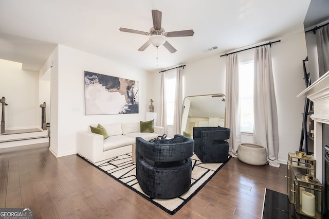 living room with ceiling fan, dark hardwood / wood-style flooring, and plenty of natural light