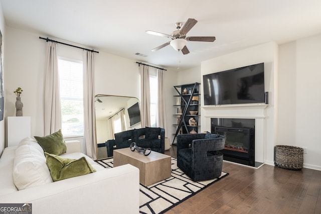 living room with ceiling fan, dark hardwood / wood-style flooring, and a healthy amount of sunlight