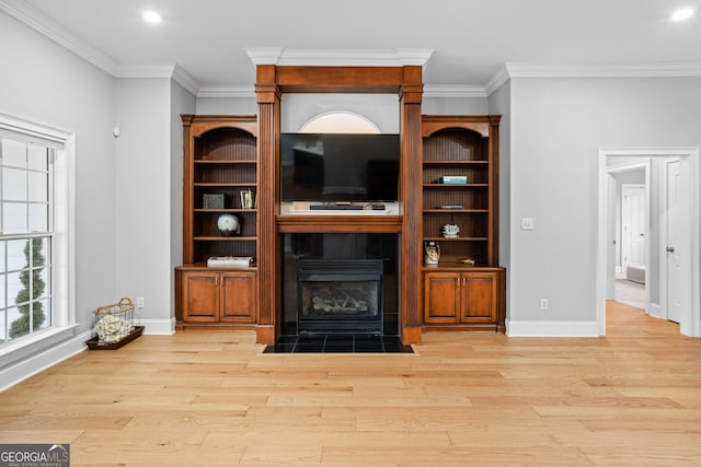 living room with light hardwood / wood-style floors and crown molding