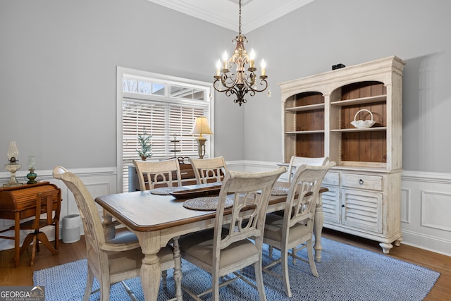 dining room featuring a chandelier, dark hardwood / wood-style floors, and ornamental molding