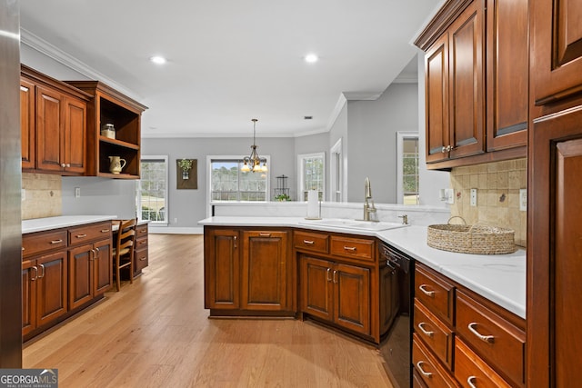 kitchen with backsplash, sink, crown molding, black dishwasher, and a notable chandelier