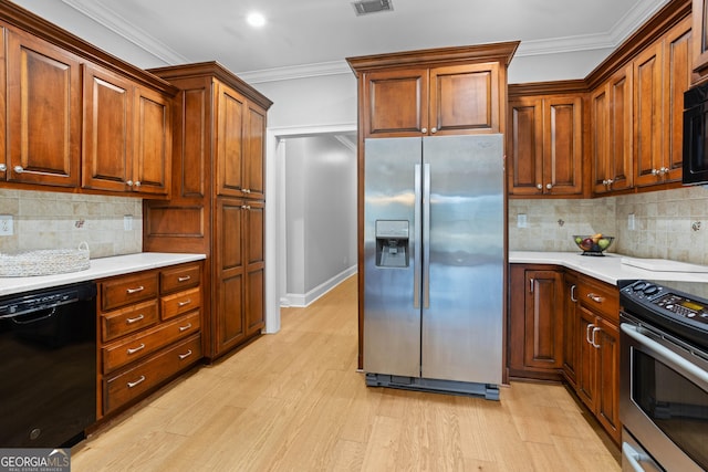 kitchen featuring decorative backsplash, light hardwood / wood-style flooring, black appliances, and ornamental molding