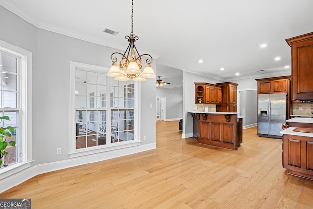 kitchen with decorative backsplash, stainless steel fridge, light hardwood / wood-style flooring, and pendant lighting