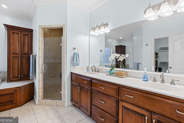 bathroom featuring tile patterned flooring, vanity, a shower with door, and ornamental molding