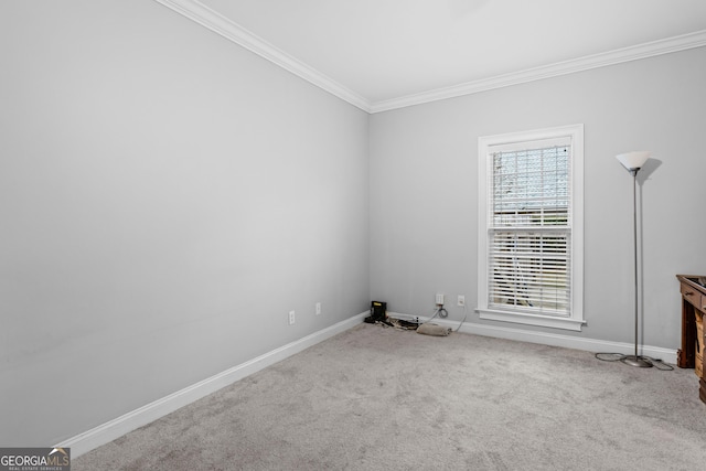 carpeted empty room featuring crown molding