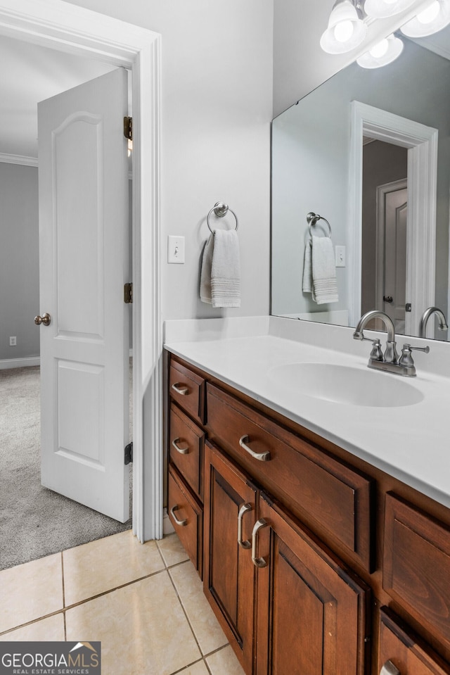 bathroom with tile patterned floors, vanity, and ornamental molding