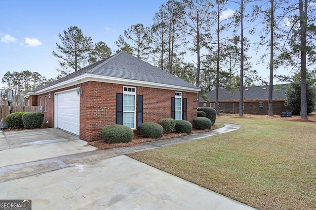 view of side of home featuring a yard and a garage