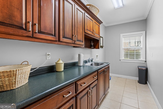 kitchen featuring crown molding, sink, and light tile patterned flooring