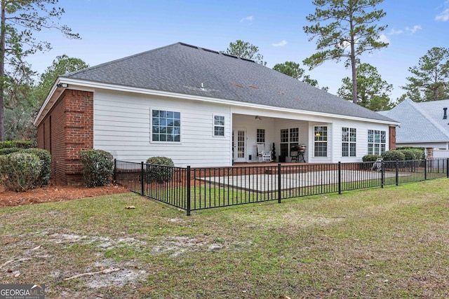 rear view of property featuring a lawn, ceiling fan, and a patio area