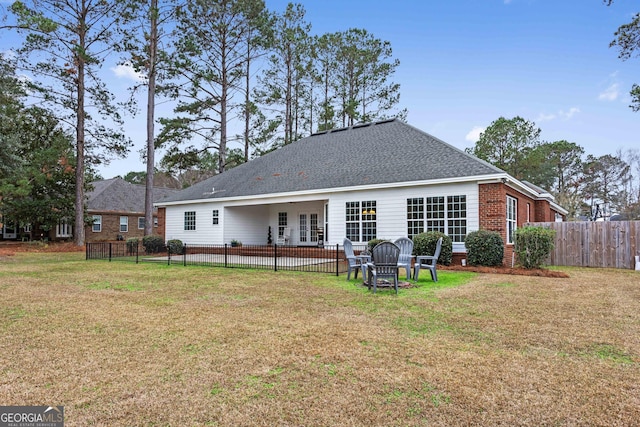 rear view of property with a lawn and a patio area