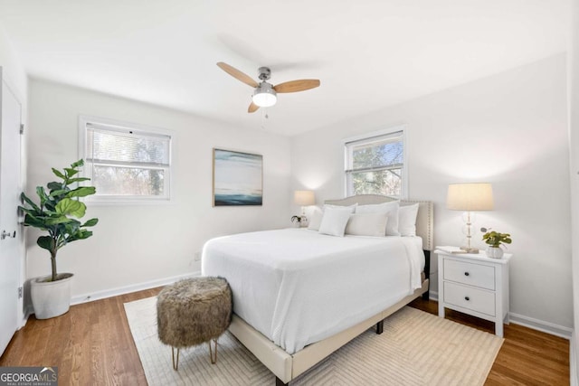 bedroom with hardwood / wood-style floors and ceiling fan