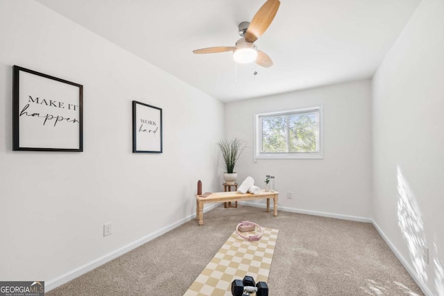 carpeted home office featuring ceiling fan