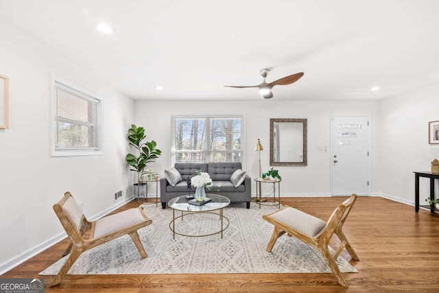 living room featuring hardwood / wood-style flooring and ceiling fan