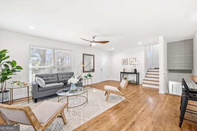 living room featuring ceiling fan and light wood-type flooring