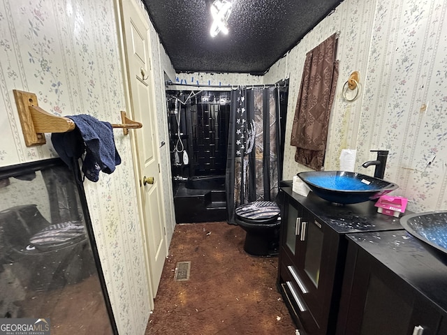 full bathroom featuring vanity, a textured ceiling, toilet, and shower / bath combo with shower curtain