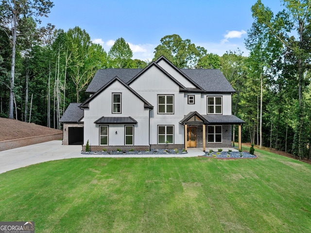 modern inspired farmhouse with a porch, a garage, and a front lawn