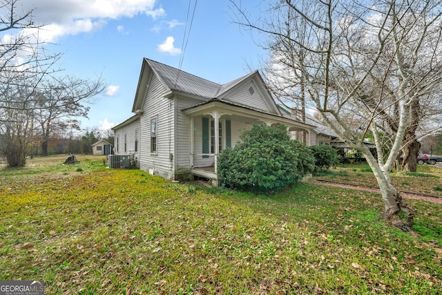 view of home's exterior featuring central AC and a yard