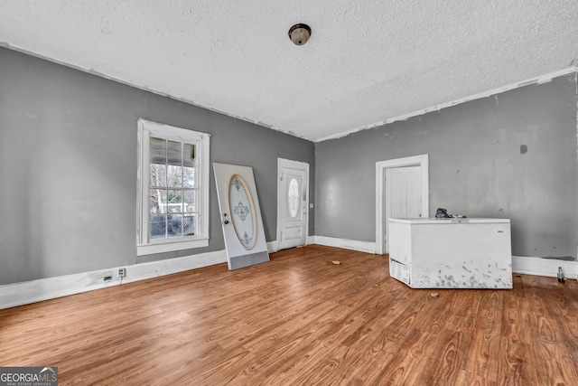 foyer with a textured ceiling and hardwood / wood-style flooring