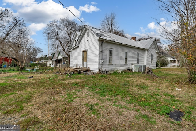 view of side of property featuring central AC unit and a trampoline