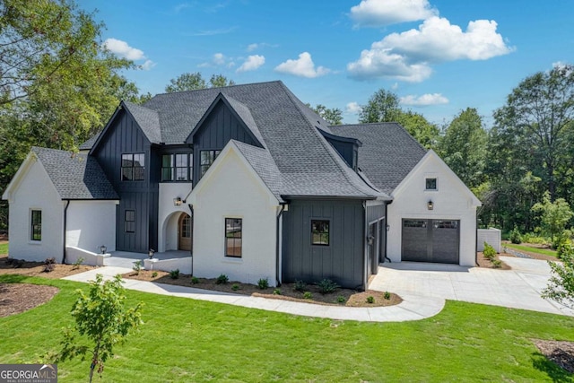 modern inspired farmhouse featuring a front yard and a garage