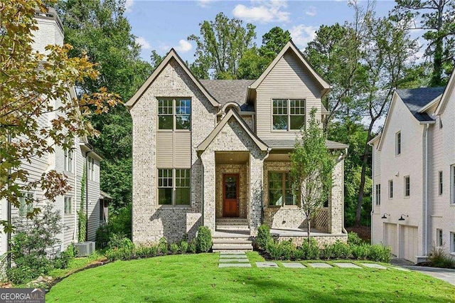 view of front of home with a garage and a front lawn