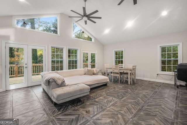 sunroom with ceiling fan, french doors, a healthy amount of sunlight, and vaulted ceiling