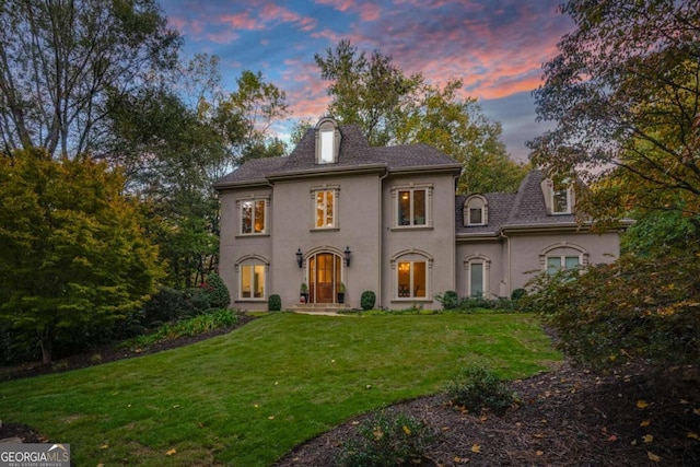 view of front of property featuring a yard and french doors