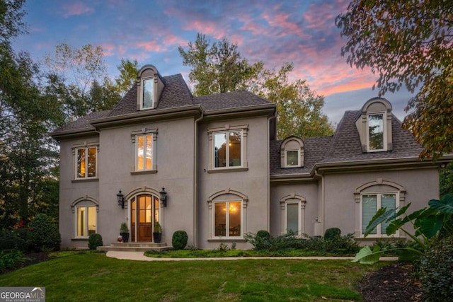 french provincial home featuring a yard