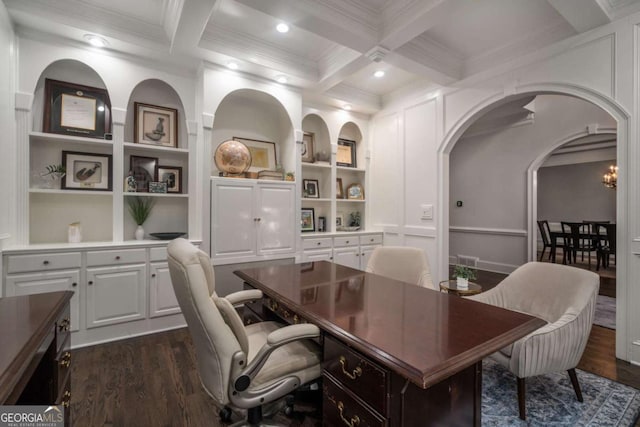 office space with coffered ceiling, crown molding, built in shelves, dark hardwood / wood-style floors, and beamed ceiling