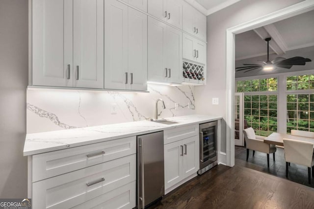 kitchen with decorative backsplash, dark hardwood / wood-style flooring, beverage cooler, ceiling fan, and white cabinets