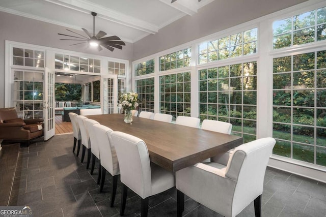 sunroom with ceiling fan and beam ceiling