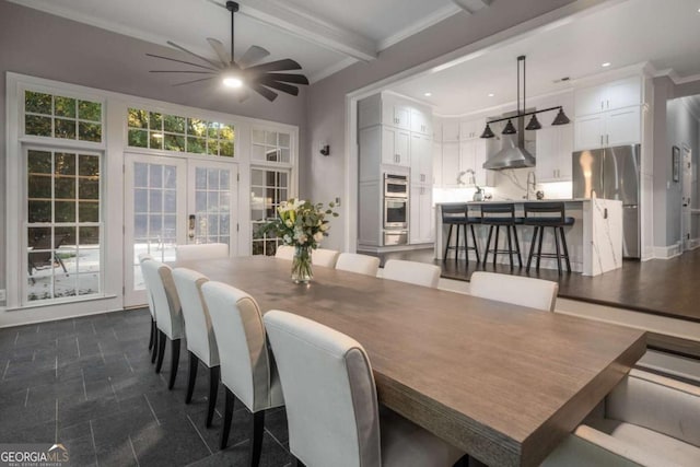 dining area with ceiling fan, french doors, beamed ceiling, and sink