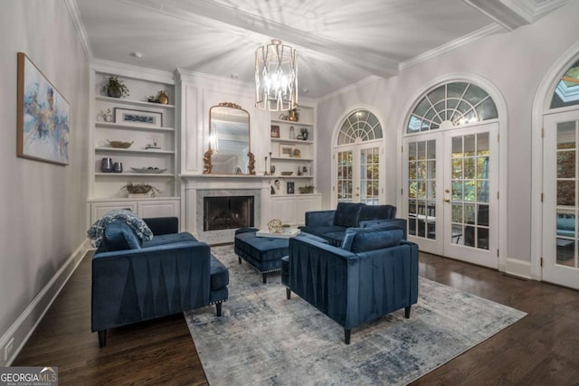 living room with french doors, dark hardwood / wood-style floors, built in shelves, beamed ceiling, and a notable chandelier