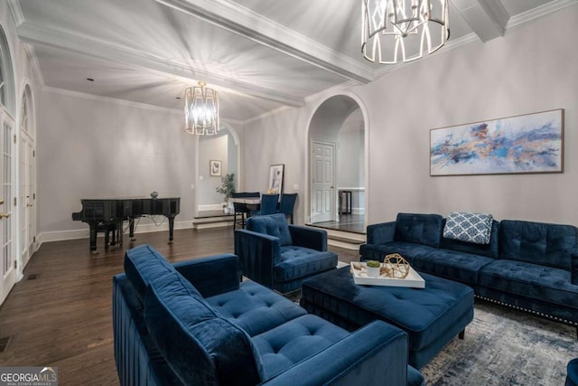 living room featuring beamed ceiling, ornamental molding, dark wood-type flooring, and an inviting chandelier