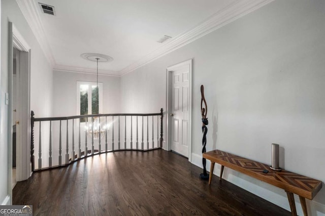 hallway featuring dark wood-type flooring, an inviting chandelier, and ornamental molding