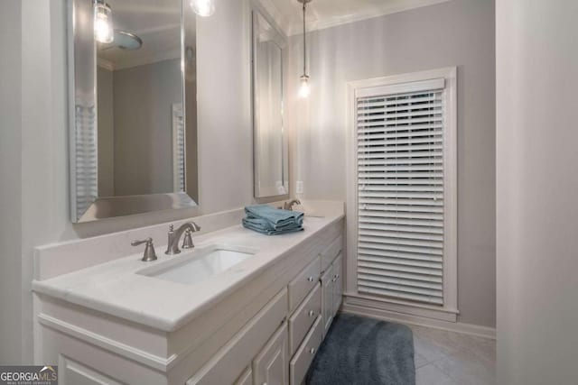 bathroom featuring tile patterned flooring, vanity, and crown molding