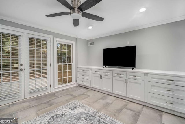 unfurnished living room featuring crown molding and ceiling fan