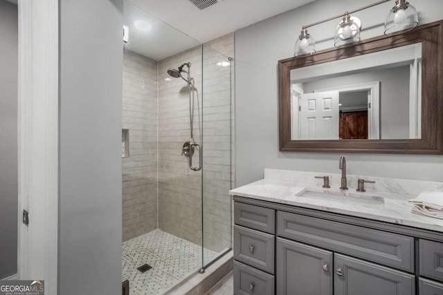 bathroom featuring vanity and an enclosed shower