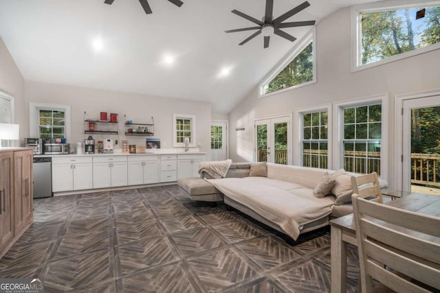 living room featuring dark parquet flooring, sink, high vaulted ceiling, and french doors