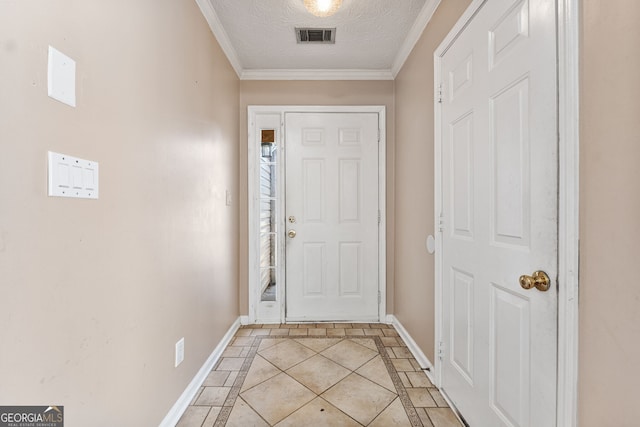 entryway with light tile patterned floors, a textured ceiling, and ornamental molding